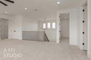 Carpeted spare room with ceiling fan with notable chandelier, recessed lighting, visible vents, and baseboards