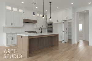 Kitchen featuring white cabinetry, light countertops, appliances with stainless steel finishes, and a sink