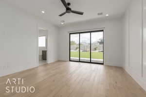 Unfurnished room with ceiling fan, visible vents, and light wood-style flooring