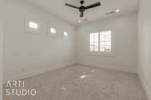 Empty room with a wealth of natural light, visible vents, carpet flooring, and baseboards
