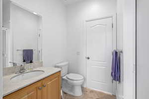 Bathroom featuring vanity, tile patterned floors, and toilet