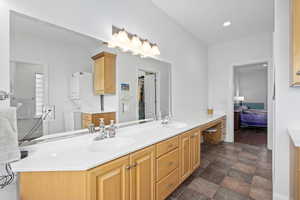 Ensuite bathroom with double vanity, ensuite bathroom, and a sink