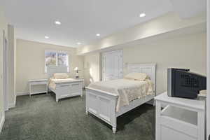 Bedroom with dark colored carpet, a closet, baseboards, and recessed lighting