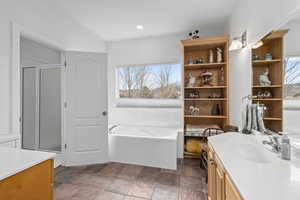 Full bath featuring vanity, recessed lighting, a shower stall, stone finish flooring, and a garden tub