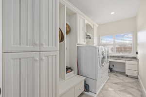 Washroom featuring cabinet space, recessed lighting, and separate washer and dryer