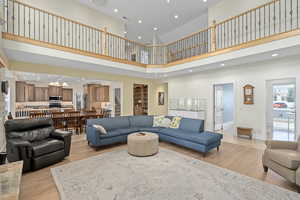 Living area with recessed lighting, baseboards, and light wood finished floors