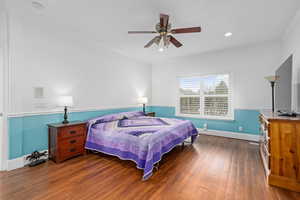 Bedroom featuring a ceiling fan, wood finished floors, recessed lighting, crown molding, and baseboards