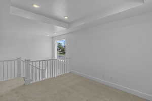 Carpeted empty room with recessed lighting and baseboards