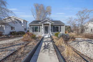 Bungalow-style house featuring roof with shingles