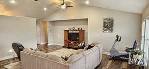 Living area featuring visible vents, lofted ceiling, and dark wood-style flooring