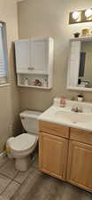 Bathroom with tile patterned flooring, toilet, and vanity