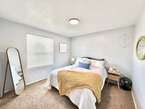 Carpeted bedroom with baseboards