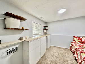 Modern lighting and neutral colors in basement bedroom.