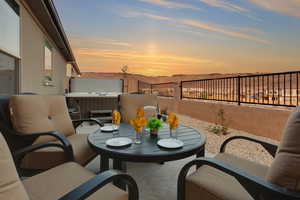 Patio terrace at dusk featuring outdoor dining area and fence