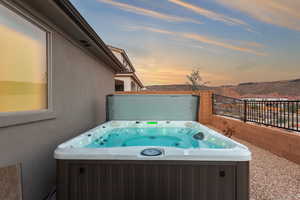 Patio terrace at dusk with a hot tub