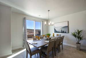 Dining room featuring baseboards, visible vents, and a chandelier