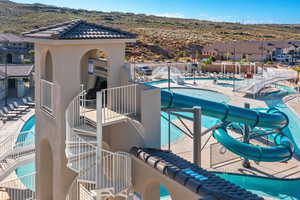 Pool featuring a patio area, a residential view, and a water slide