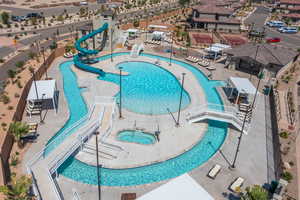 View of pool featuring a patio, a water slide, and a community hot tub