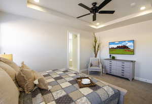 Bedroom featuring carpet, baseboards, ensuite bath, a tray ceiling, and recessed lighting