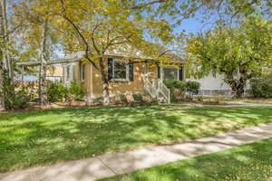 View of front of house with brick siding and a front yard