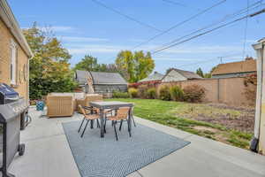 View of patio featuring outdoor lounge area, an outbuilding, outdoor dining area, and a fenced backyard