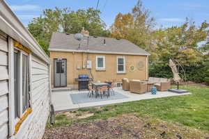 Back of property with a patio, roof with shingles, outdoor lounge area, a lawn, and brick siding