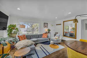 Living room featuring crown molding, recessed lighting, and wood finished floors