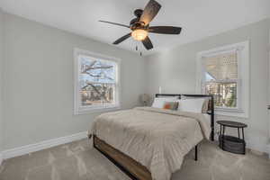 Bedroom with carpet flooring, a ceiling fan, and baseboards