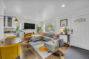 Living room featuring recessed lighting, ornamental molding, and wood finished floors