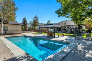 View of pool featuring a patio, fence, a fenced in pool, a yard, and a gazebo