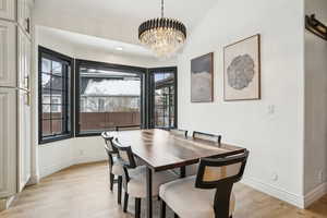 Dining space with light wood-style flooring, recessed lighting, baseboards, and a chandelier