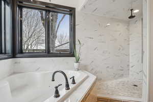 Full bath with a tile shower and a garden tub