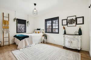 Bedroom featuring baseboards and wood finished floors