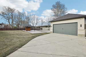 View of yard featuring a gazebo, driveway, and fence