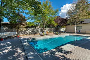 View of swimming pool featuring outdoor lounge area, a patio area, a fenced backyard, and a fenced in pool