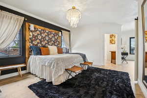 Bedroom with multiple windows, crown molding, and wood finished floors