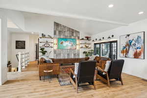 Living area with beamed ceiling, recessed lighting, baseboards, and light wood-type flooring