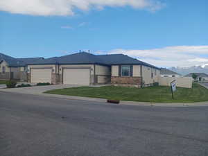 View of front of house with a garage, concrete driveway, and a mountain view
