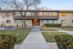 View of front of house featuring brick siding and a front lawn