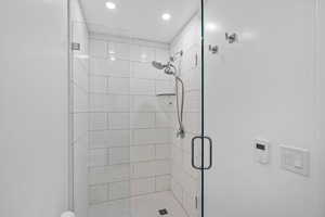 Bathroom featuring recessed lighting and a stall shower