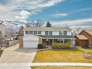 Front porch, two car garage, RV parking, and fenced yard.