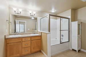 Full bathroom with double vanity, shower / bath combination