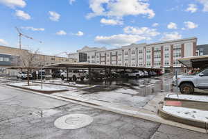 View of condo's community with covered parking