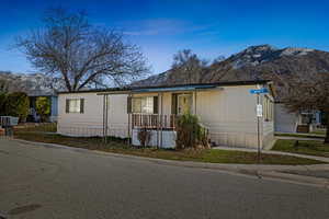 Manufactured / mobile home featuring a mountain view and a porch