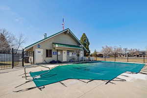 Pool with a patio and fence