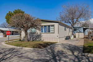 Manufactured / mobile home with a storage shed and an outbuilding