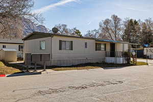 Manufactured / mobile home with a storage shed, an outbuilding, and a mountain view