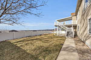 View of yard featuring stairway and fence