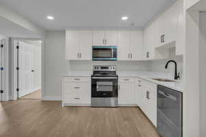 Second Kitchen featuring a sink, light countertops, light wood-style floors, and stainless steel appliances