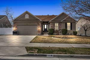 Single story home with stucco siding, driveway, an attached garage, and fence